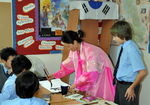 Mrs Hill shows the boys how to write in Korean