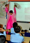 Mrs Hill shows the boys a traditional Korean dance